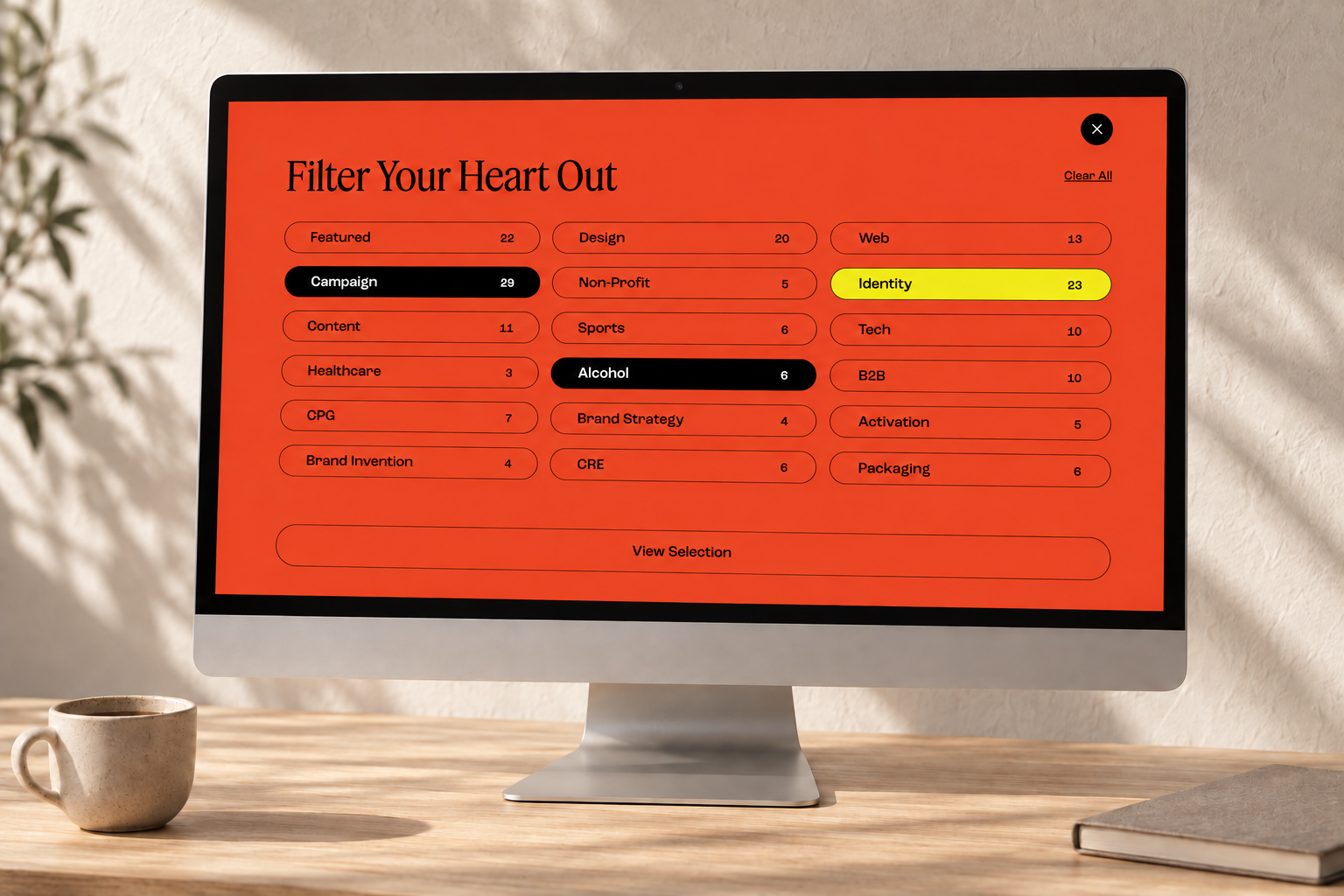 Colossus project filtering interface on a desktop monitor in a warm, naturally lit creative studio