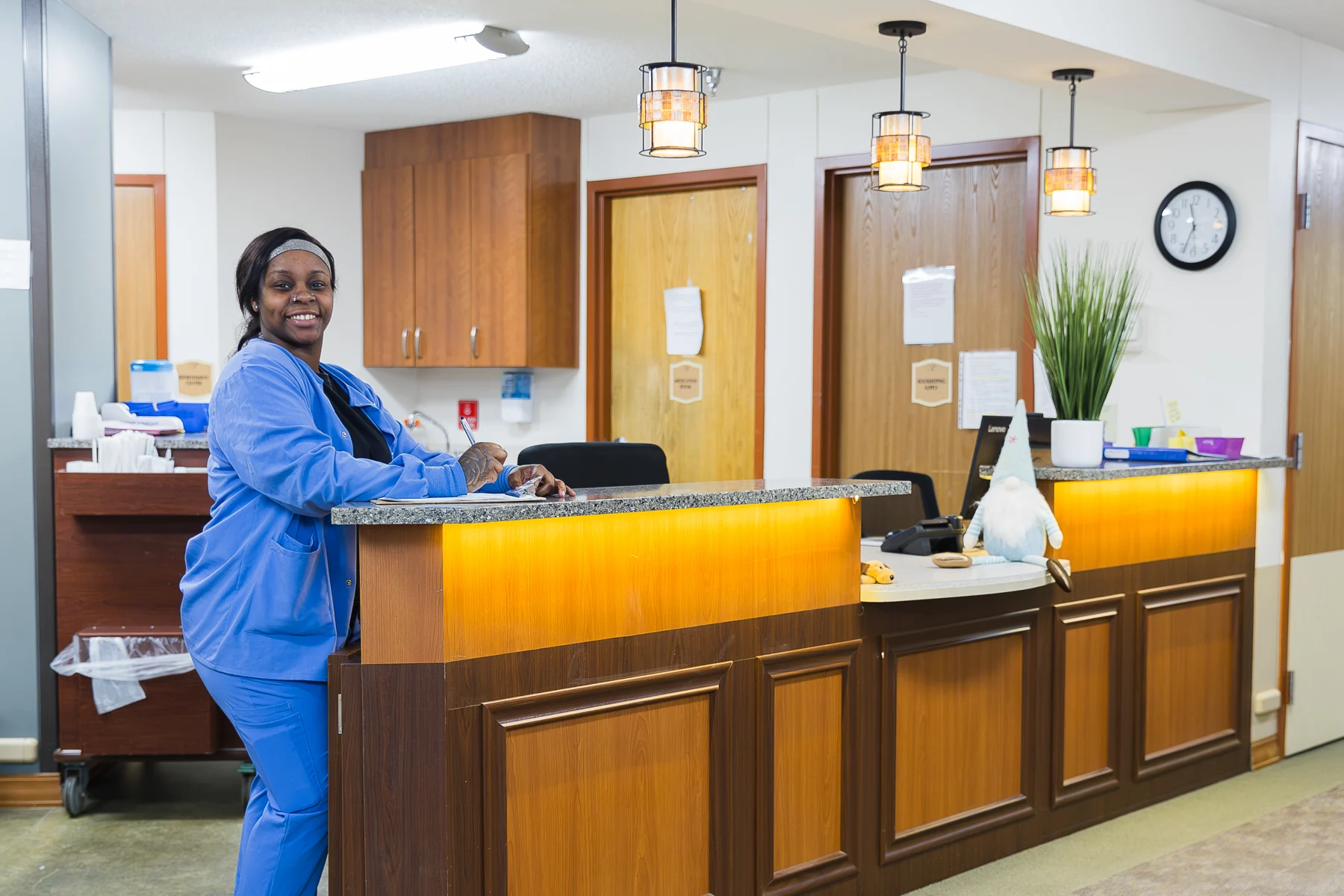 A smiling staff member at the reception desk